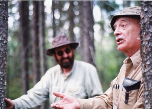 Bob Killam looks on as Ken Armson explains black spruce monoculture that developed after wildfire